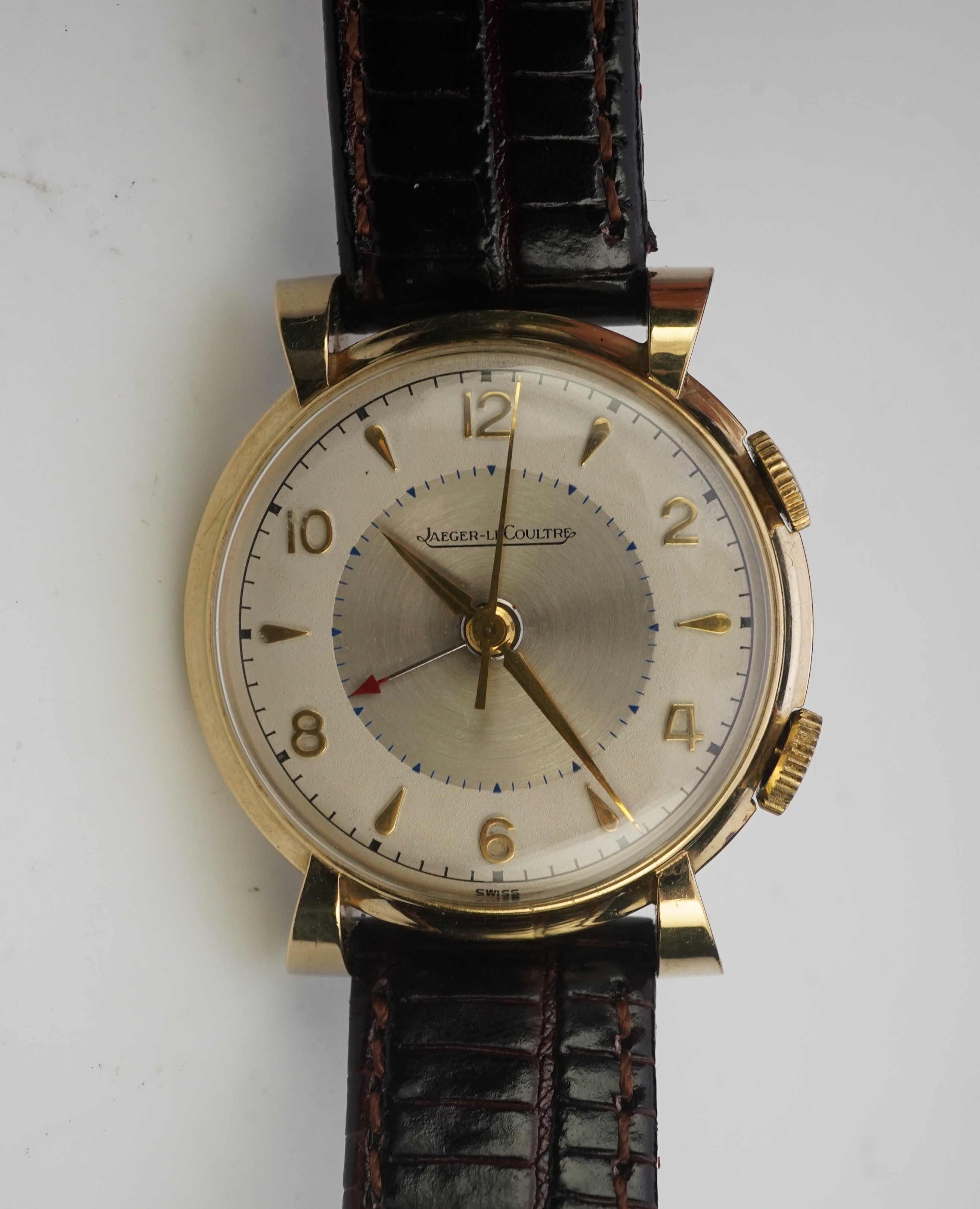 A gentleman's 1950's gold plated Jaeger LeCoultre Memovox manual wind wrist watch, on a later associated leather strap